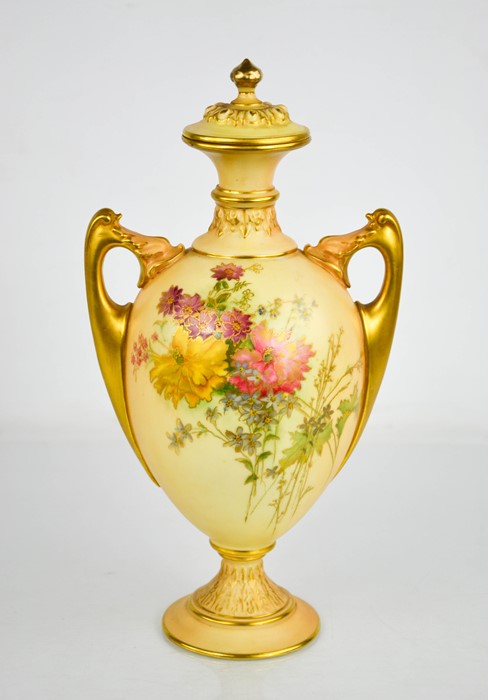 A Royal Worcester blush ivory vase and cover, painted with flowers all over with finialled lid and