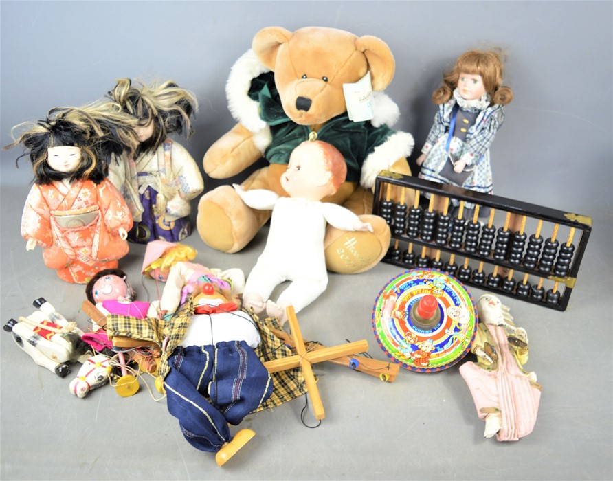 A group of vintage dolls and string puppets together with a Harrods teddy bear