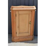 A pine corner cupboard.