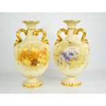 A pair of Royal Worcester vases, finely painted with flowers on a peach and ivory ground, with