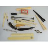 A group of bone glove stretchers, Bramah and Prestage ruler, button hook etc