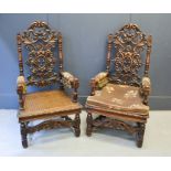 A pair of 19th century oak throne style armchairs, with carved scrollwork back, upholstered arms and