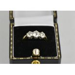 An 18ct gold three stone diamond trilogy ring, 1ct total diamond weight, size L½, 3g.