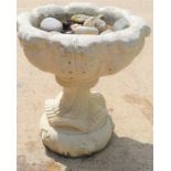 A reconstituted stone garden planter on stand.