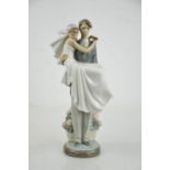 A Lladro porcelain figurine, man carrying bride in his arms.