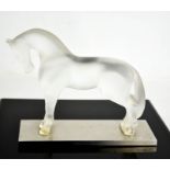 A Lalique opaque glass horse on metal base, signed to the back feet Lalique, France, bearing label