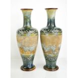 A pair of Doulton Lambeth vases by Hannah Barlow with bands of does and sheep to the mottled green