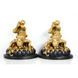 A pair of modern French style black and gilded wall brackets in the form of monkeys, 34cm high.