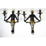 A pair of Blackamore wall lights, with twin candle sockets raised on scrollwork branches, ebonised