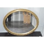 A giltwood mirror of oval form