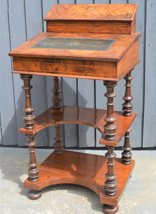 A Victorian mahogany davenport with correspondence compartment over sloped front and two shaped