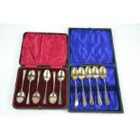 Two sets of silver spoons, in presentation boxes. (one spoon missing).