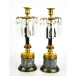 A pair of Empire style early 20th century bronze, ormolu and marble candlesticks, the candle sockets