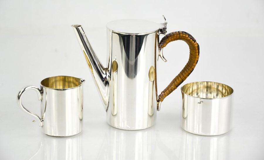 A mid-century silver plated miniature coffee set, comprising coffee pot, sugar bowl, and milk jug.