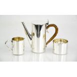 A mid-century silver plated miniature coffee set, comprising coffee pot, sugar bowl, and milk jug.