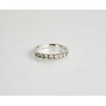 An 18ct white gold and diamond ring, the seven diamonds totalling 0.4ct, size K½.