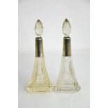 A pair of cut glass perfume dressing table bottles with glass stoppers, London 1903, 19cm high.