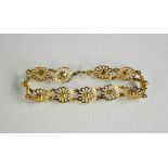 A 9ct gold bracelet, composed of flowerhead links, 7.16g.