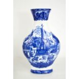 A Victorian blue and white vase, depicting continental town scenes, 35cm high.