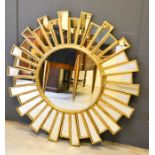 A gilt metal starburst mirror, in the Art Deco style, the roundel centre bordered by mirrored