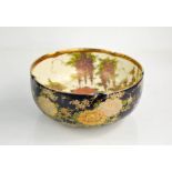 A Satsuma ware porcelain bowl, decorated with ducks in a pond, the exterior with blue ground, 18cm