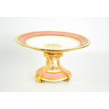 A 19th century Minton porcelain comport, with a pink ground, enhanced with gilded decoration, raised