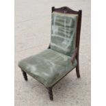 A Victorian nursing upholstered in green upholstery