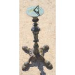 A bronze sundial on a cast iron base, 75cms tall