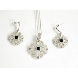 A 9ct white gold, diamond and sapphire pair of earrings and matching necklace, the flower form