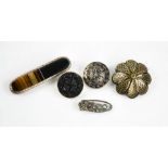A group of brooches to include one in agate and silver a tortoiseshell, silver and gold, and a