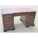 A Chinese hardwood pedestal desk with decorative panels to side and rear, 151 by 89 by 76cm.