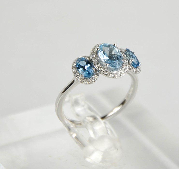 An 18ct gold aquamarine and diamond trilogy ring, J½, 2.65g. - Image 2 of 2