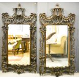 A pair of wall mirrors, open carved with rococo scrollwork and having Chinoiserie pagoda