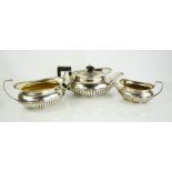 A George III silver three piece tea set by Robert and Samuel Hennell, London 1805, of oval form,