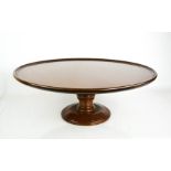 A 19th century mahogany 'Lazy Susan', the roundel top revolving on a turned base, 51cm diameter.