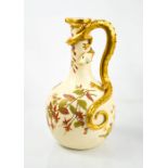 A Royal Worcester blush ivory jug modelled with a gilded lizard with blue glass eyes, the body