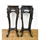 Two similar Chinese jardinere stands, the hardwood carved octagonal tops inset with marble, above