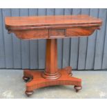 A mahogany card table with swivel top, green baize lining and x-form base, 75cm high by 92cm wide by