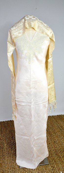 An early 20th century cream silk scarf, embroidered with decoration, and a fine silk full length