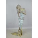 A metal sculpture of a partially nude lady with towel, 63.5cm high