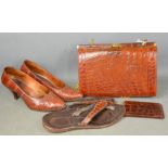 A group of vintage crocodile skin items to include handbag, shoes, flip-flops and wallet.