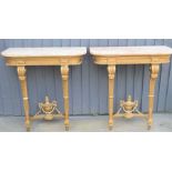 A pair of Louis XVI style giltwood and marble top console tables with twin turned, carved and