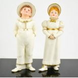 A Royal Worcester pair of figures in the Kate Greenway style, holding a wicker basket modelled as