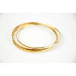 A rose, yellow and white gold (tested as 9ct) bangle, 10g.