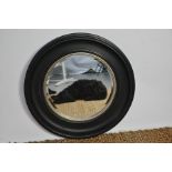 An ebonised roundel wall mirror, 68cm diameter