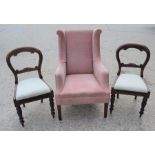 Two Victorian mahogany dining chairs with turned legs together with a wingback armchair