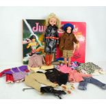 Two vintage Sindy dolls, together with vintage clothing including Sindy examples and two Sindy