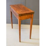 A George III mahogany and inlaid writing table / games table with revolving top, which opens out