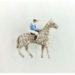 A fine platinum, diamond and enamel brooch in the form of horse and jockey, the horse set with