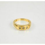 A 9ct gold and diamond three stone ring, size U/V, 5.1g.